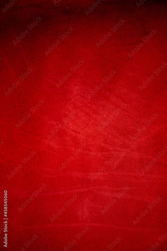 Dark red matte background of suede fabric, closeup. Velvet texture of seamless wine leather.