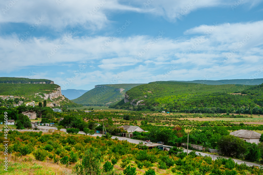 A village between two green hills, Crimea. Mountain landscape in summer