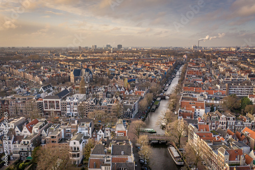 Sunset Over Amsterdam City with its Canals and Waterways Aerial View
