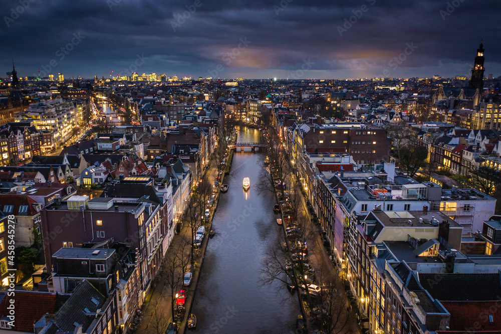 Amsterdam City Canals at Night with a Tour Boat Aerial View