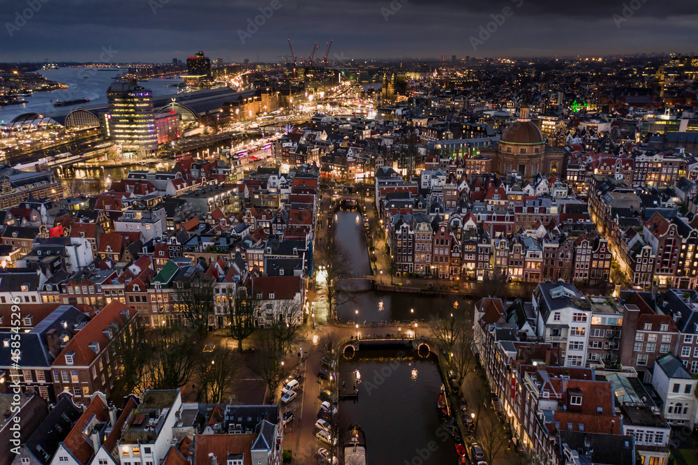 Amsterdam City at Night With Canals Illuminated by Surrounding Houses
