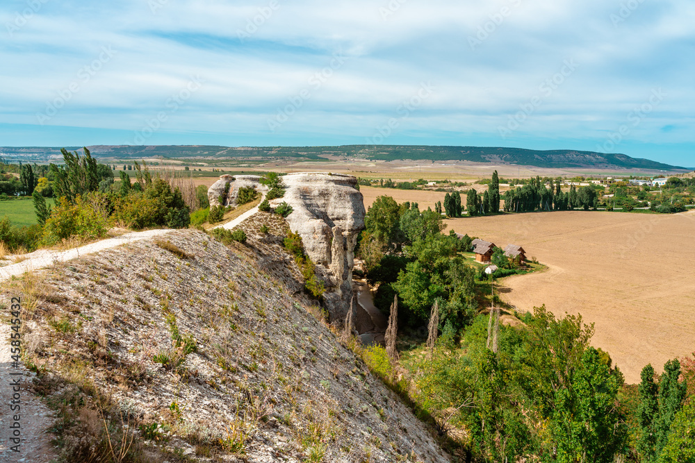 Beautiful summer landscape with rocks and views of the green hills of the valley, mountain landscape in the Crimea Beautiful summer landscape with rocks and views of the green hills of the valley, mountain landscape in the Crimea