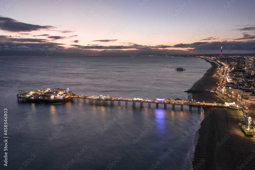 Brighton Seafront Palace Pier and West Pier at Sunset Aerial View