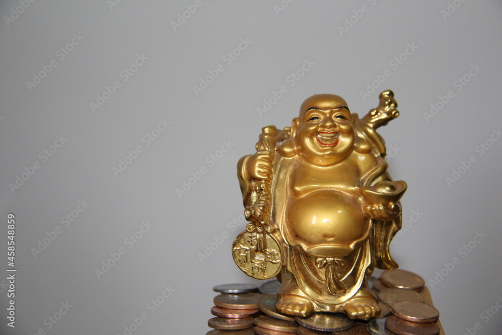 Smiling Buddha: Coins on Feet, Chinese God of Happiness, Wealth and Luck. Isolated on a light background.
Smiling Buddha: Coins on Feet, Chinese God of Happiness, Wealth and Luck. Isolated on a light background.