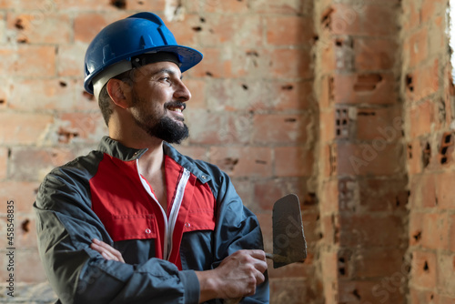 Photos Bricklayer poses smiling while renovating a bathroom