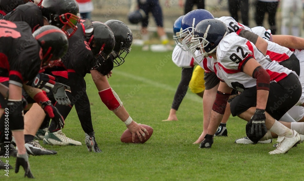 People Playing American Football on a green stadium People Playing American Football on a green stadium