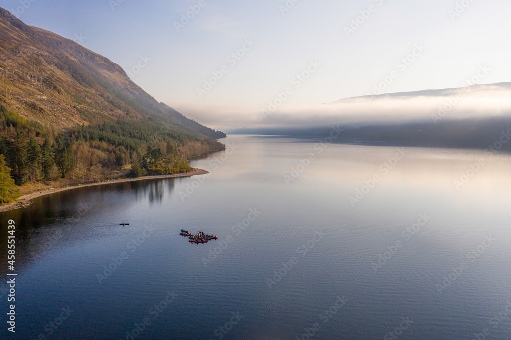 Large Group of Canoeists on a Lake at Sunrise