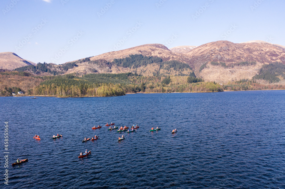 Large Group of Canoeists on a Lake With Mountain Landscape