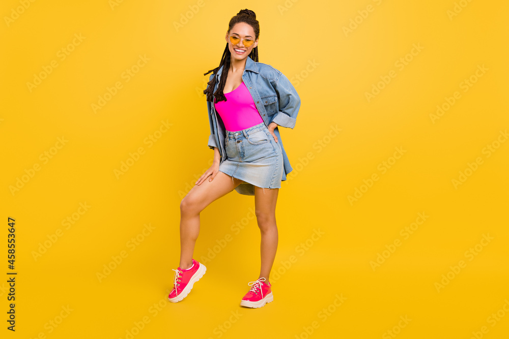 Full body photo of young afro girl happy positive smile fancy cool hipster isolated over yellow color background Full body photo of young afro girl happy positive smile fancy cool hipster isolated over yellow color background