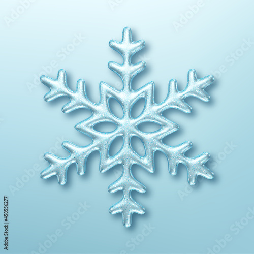 Three dimensional shiny snowflake on blue background. Design element for Christmas greeting card