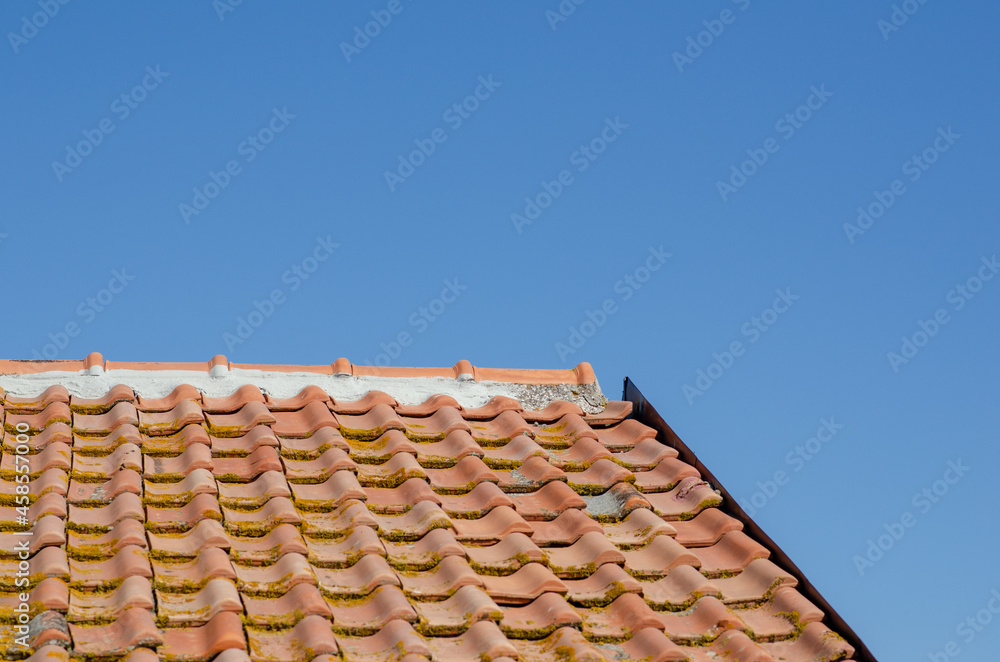 House: building with pitched roof with brick tiles, visible the upper pitch line, ridge tiles and steel front. House: building with pitched roof with brick tiles, visible the upper pitch line, ridge tiles and steel front.