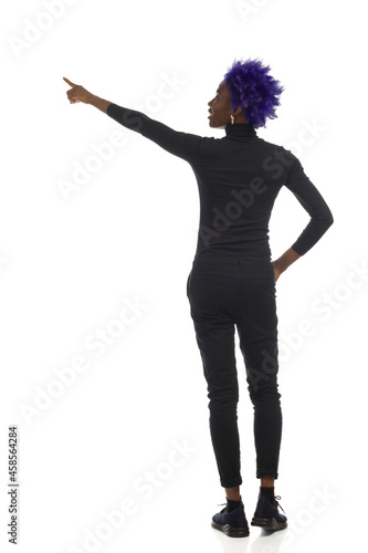 Black Woman Is Standing And Pointing. Full Length, Isolated, Rear View.