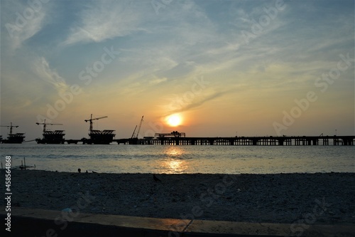 MALE ISLAND, MALDIVES - JANUARY 06,2018: a sunset view of bridge under construction for background, cranes, selective focus