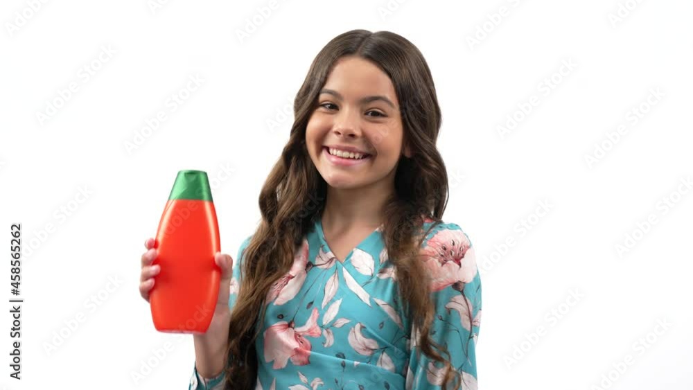 cheerful teen girl turning presenting using canditioner bottle isolated on white, advertisement. cheerful teen girl turning presenting using canditioner bottle isolated on white, advertisement.