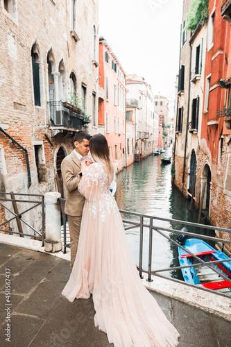 Gorgeous happy couple standing close to each other and looking in eyes in Venice, Italy © olegparylyak