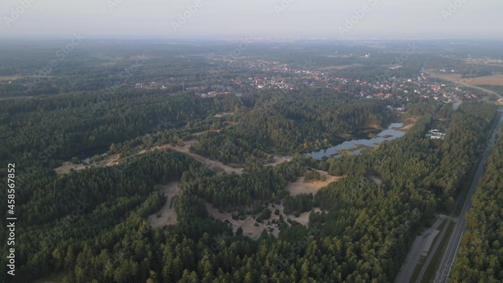 Sunrise over the land of forests and lakes.Flight over ferests small lakes in the early morning at sunrise. Sunrise over the land of forests and lakes.Flight over ferests small lakes in the early morning at sunrise.