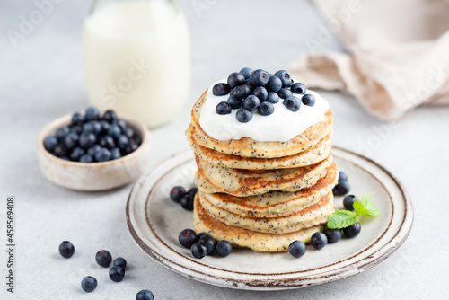 Vászonkép Stack of lemon poppy seed pancakes topped with yogurt and blueberries