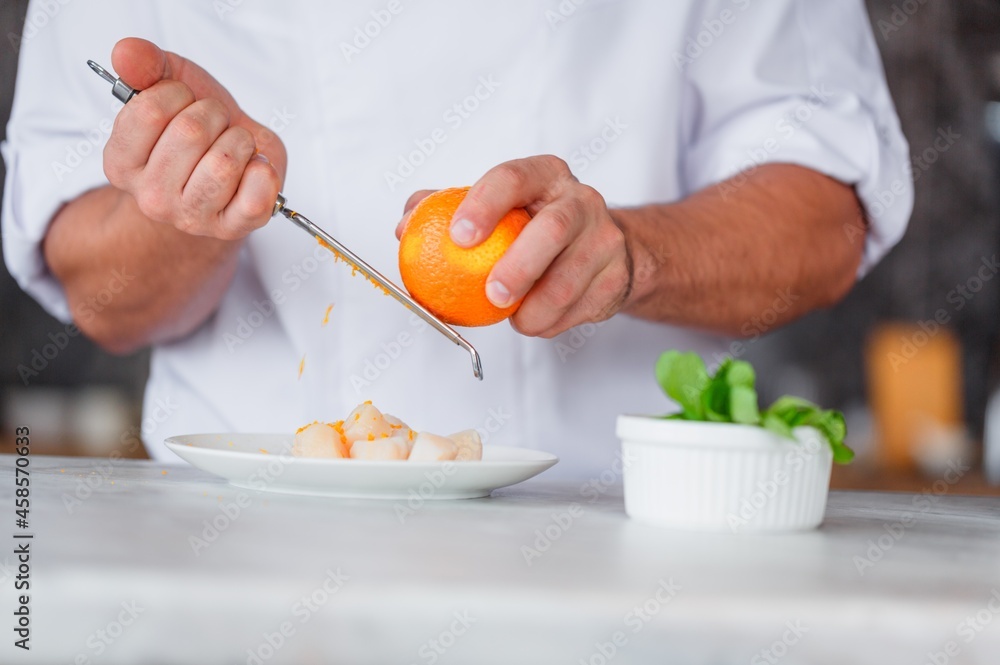 Chef hand cooking penne with cheeze and sun-dried in a white plate Chef hand cooking penne with cheeze and sun-dried in a white plate