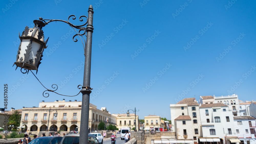 Old-fashioned street lamp on the famous bridge of Ronda, Andalusia, Spain, named 