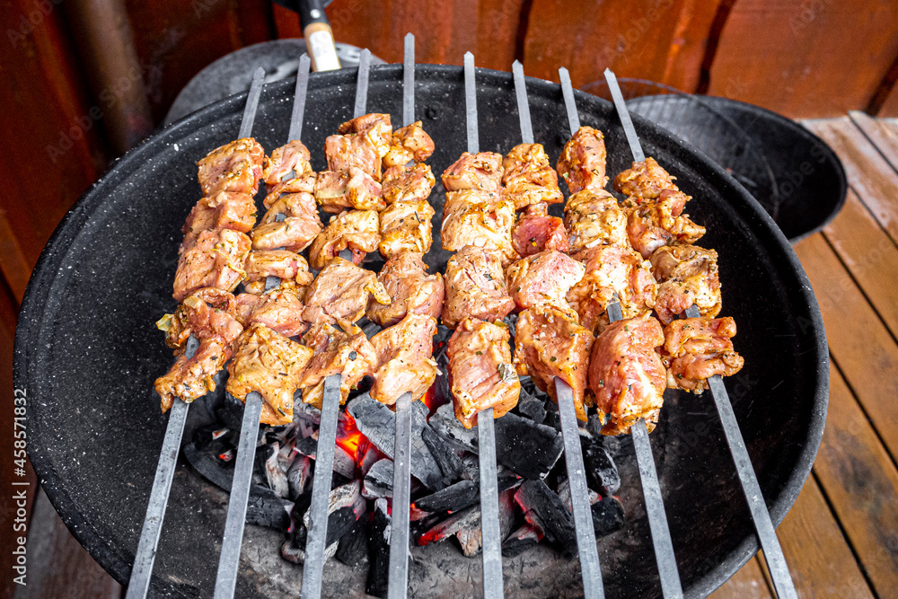 Russian shashlik with skewers on a round grill.