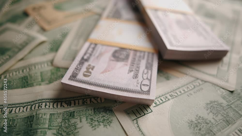 American 100 and 50 dollar banknotes close up. Concept of saving money or monetary inflation and cash flow. American 100 and 50 dollar banknotes close up. Concept of saving money or monetary inflation and cash flow.