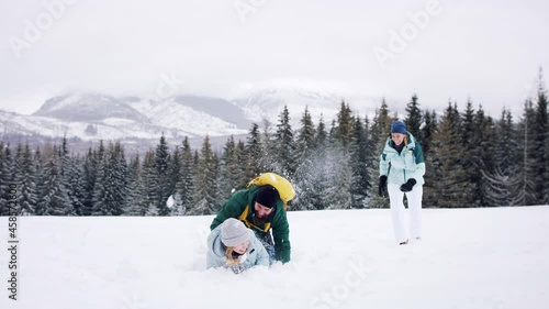 Family with small daughter having fun outdoors in winter nature. Tatra mountains Slovakia. photo