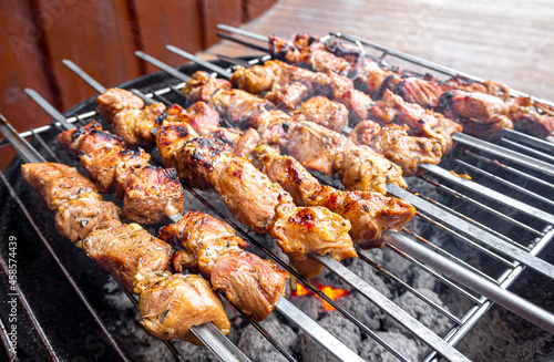 Russian shashlik with skewers on a round grill.