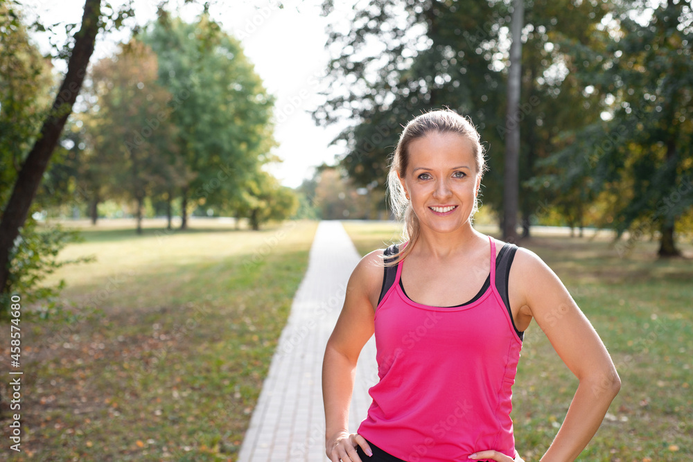 Beautiful mature blonde woman running at the park on a sunny day. Beautiful mature blonde woman running at the park on a sunny day.