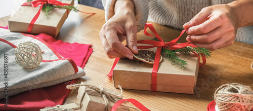 Christmas gift zero waste, eco friendly hand made box packaging gifts in kraft paper wooden table, eco christmas holiday concept, Christmas gift wrapping,eco decor banner photo