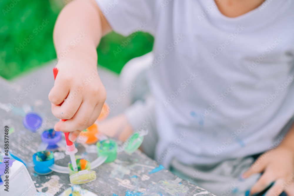 DIY Plaster Model Painting with colorful paints,Little child painting the plaster model,Creative concept. Water colors. DIY Plaster Model Painting with colorful paints,Little child painting the plaster model,Creative concept. Water colors.