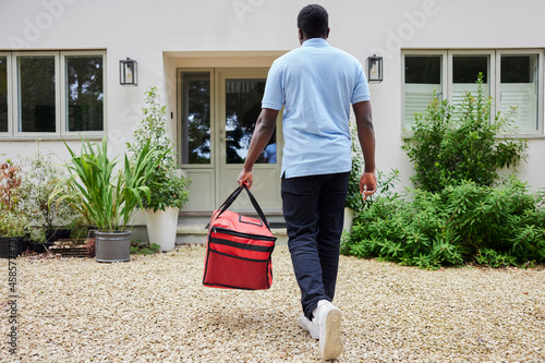 Photography Rear View Of Gig Economy Driver Delivering Online Takeaway Food Order To House