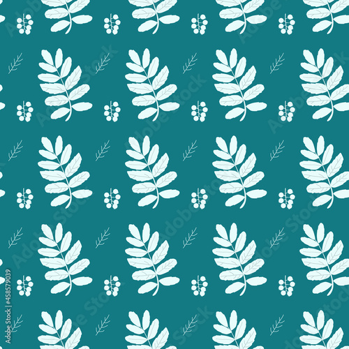 Seamless pattern of mountain ash leaves on a blue background for prints and decorations