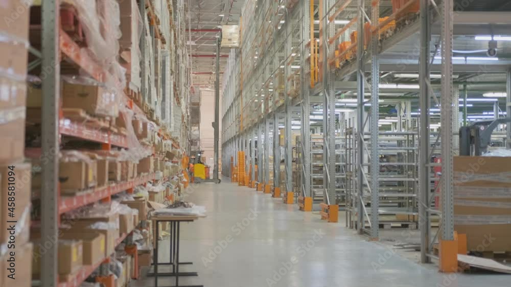 worker on forklift telescopic loader moves pallets with goods by lifting them onto shelf in storage warehouse. worker on forklift telescopic loader moves pallets with goods by lifting them onto shelf in storage warehouse.