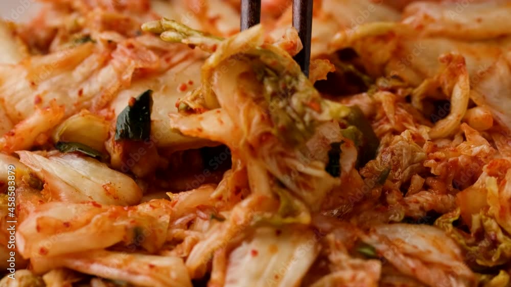 Eating Traditional Korean Kimchi Cabbage using chopstick. Healthy food Eating Traditional Korean Kimchi Cabbage using chopstick. Healthy food