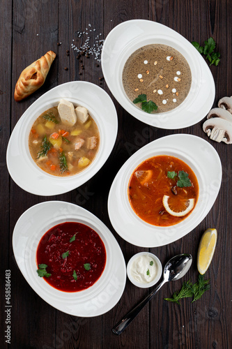 Assortment of soups in a restaurant menu: mushroom cream soup, peasants' soup, borsch and chicken soup