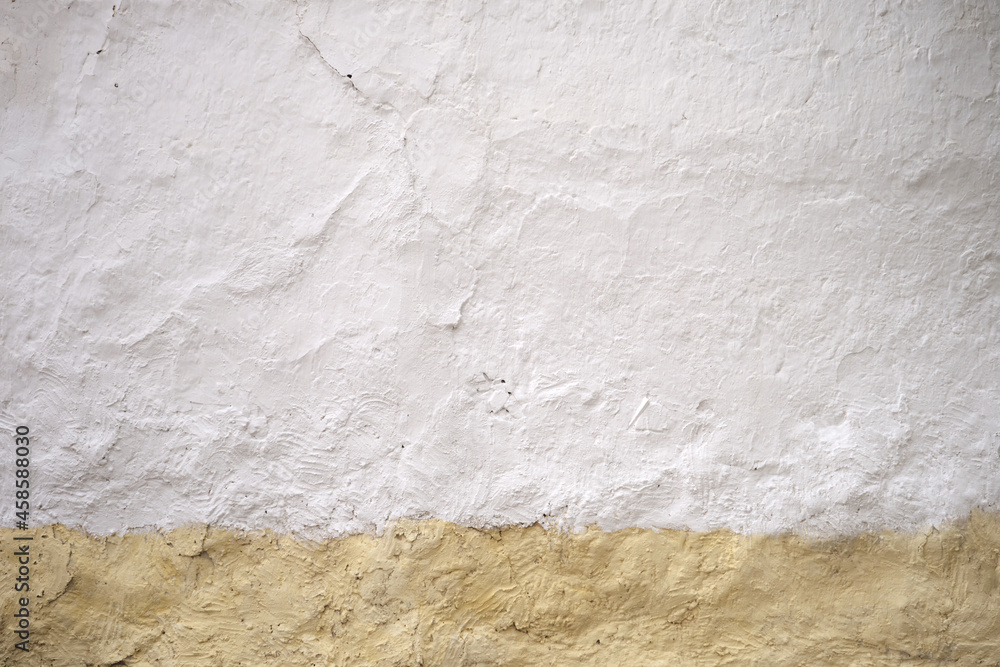 Old whitewashed wall with yellow skirting board Old whitewashed wall with yellow skirting board