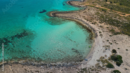 Aerial drone photo of paradise turquoise secluded sandy beach of Lefki or White in island of Elafonisos next to popular beach of Simos, South Peloponnese, Lakonia, Greece photo