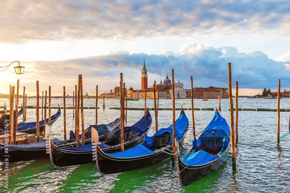 Gondolas moored in front of San Giorgio Maggiore Island in the lagoon of Venice, Italy
