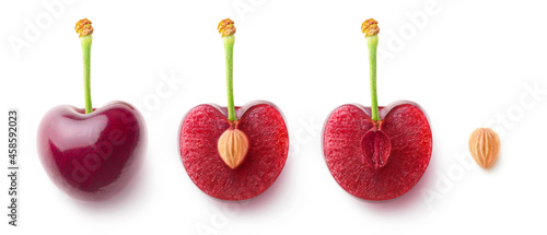 Cherry fruit halves and a pit in a row, flat lay isolated on white background 