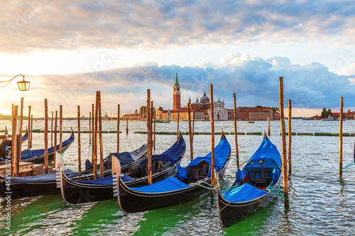 Gondolas moored in front of San Giorgio Maggiore Island in the lagoon of Venice, Italy
