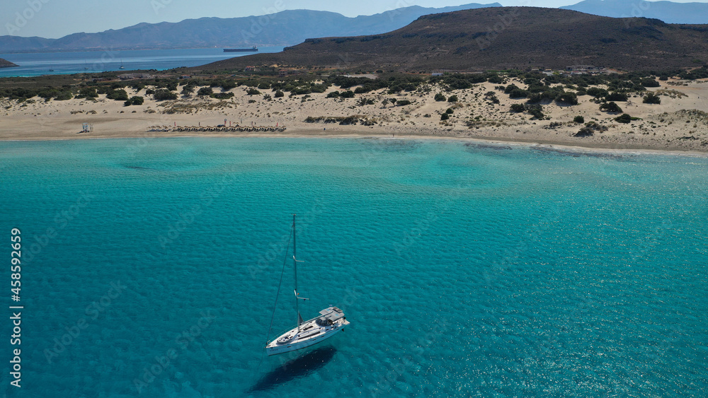Obraz premium Aerial drone photo of paradise turquoise sandy beach and bay of Simos in island of Elafonisos visited by yachts and sail boats, South Peloponnese, Lakonia, Greece