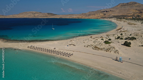 Fototapeta Naklejka Na Ścianę i Meble -  Aerial drone photo of paradise turquoise sandy beach and bay of Simos in island of Elafonisos visited by yachts and sail boats, South Peloponnese, Lakonia, Greece