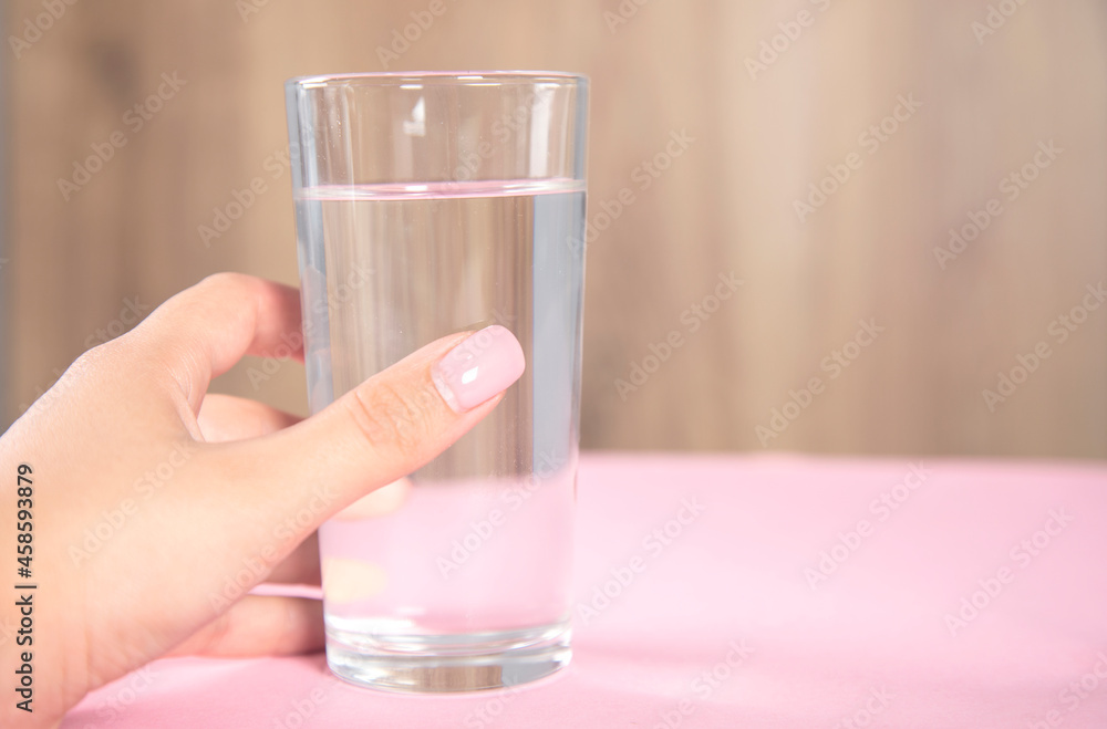 woman holding glass of water woman holding glass of water