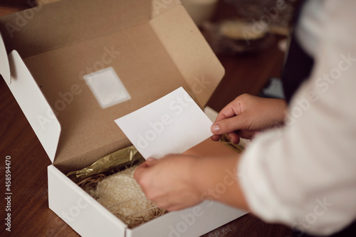 small business owner, online marketing packaging box and delivery. A parcel wrapped in brown paper. Delivery concept for private companies delivery with care. Craft present box