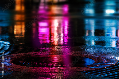 Lights and shadows rain night, autumn city. Neon street illumination after night rain. Night cityscape, colored lights reflected in Humidity wet asphalt