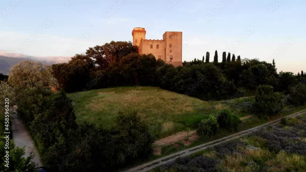 Aerial drone view from bird's eye on historical castle tower located in nature environment with breathtaking landscape for travelling, above scenery of burg town with belfry during sunset time Aerial drone view from bird's eye on historical castle tower located in nature environment with breathtaking landscape for travelling, above scenery of burg town with belfry during sunset time