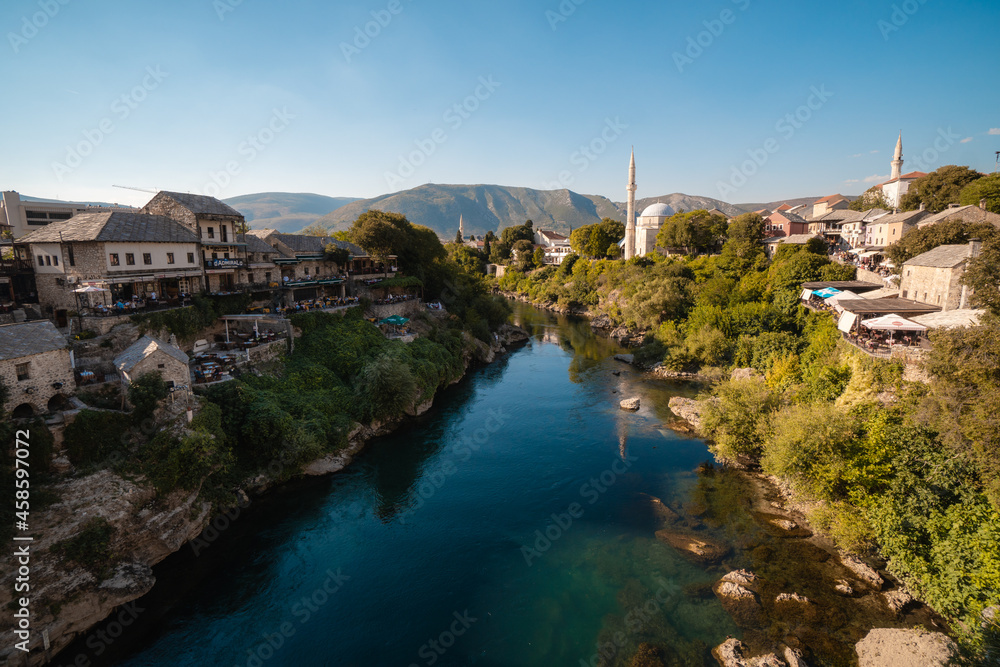 Mostar, Bosnia and Herzegovina - September 12 2021: View over Neretva river during a sunny day in Mostar, touristic destination in Bosnia and Herzegovina, Europe