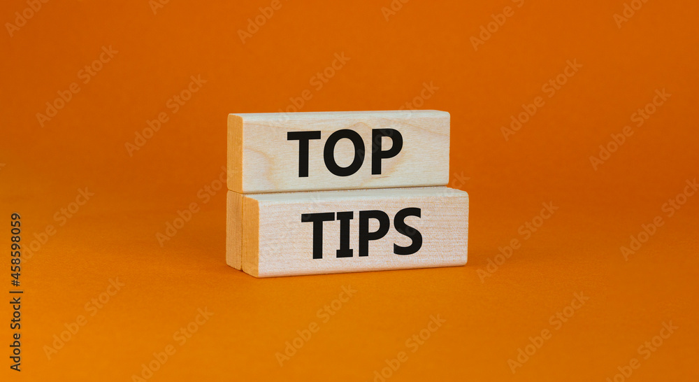Top tips symbol. Concept words Top tips on wooden blocks on a beautiful orange background. Business and Top tips concept, copy space. Top tips symbol. Concept words Top tips on wooden blocks on a beautiful orange background. Business and Top tips concept, copy space.