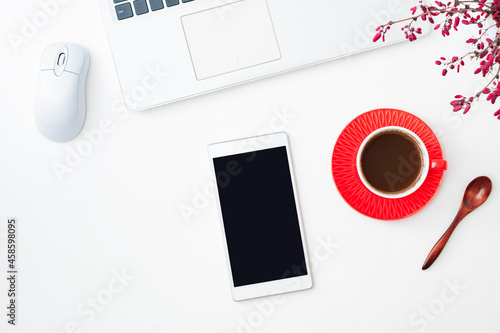 Flat Lay mockup of smartphone with blank screen and cup of coffee, branches with red berries, laptop on a white background