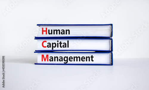 HCM, Human capital management symbol. Concept words HCM, Human capital management on books on a beautiful white background. Business, HCM, Human capital management concept. Copy space.